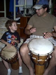 Max and his dad take a hand drumming lesson