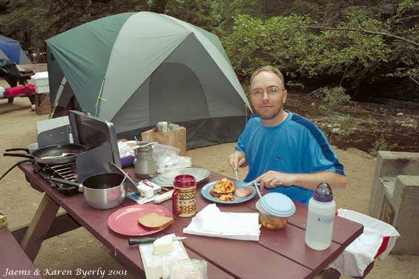 Jim eating breakfeast on the banks of the Big Sur River